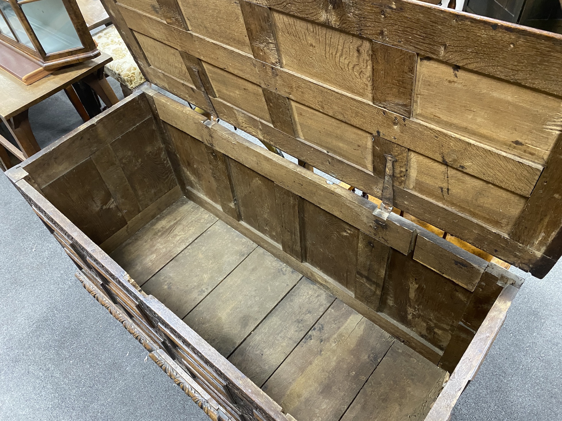 An 18th century carved panelled oak coffer, width 153cm, depth 61cm, height 65cm
